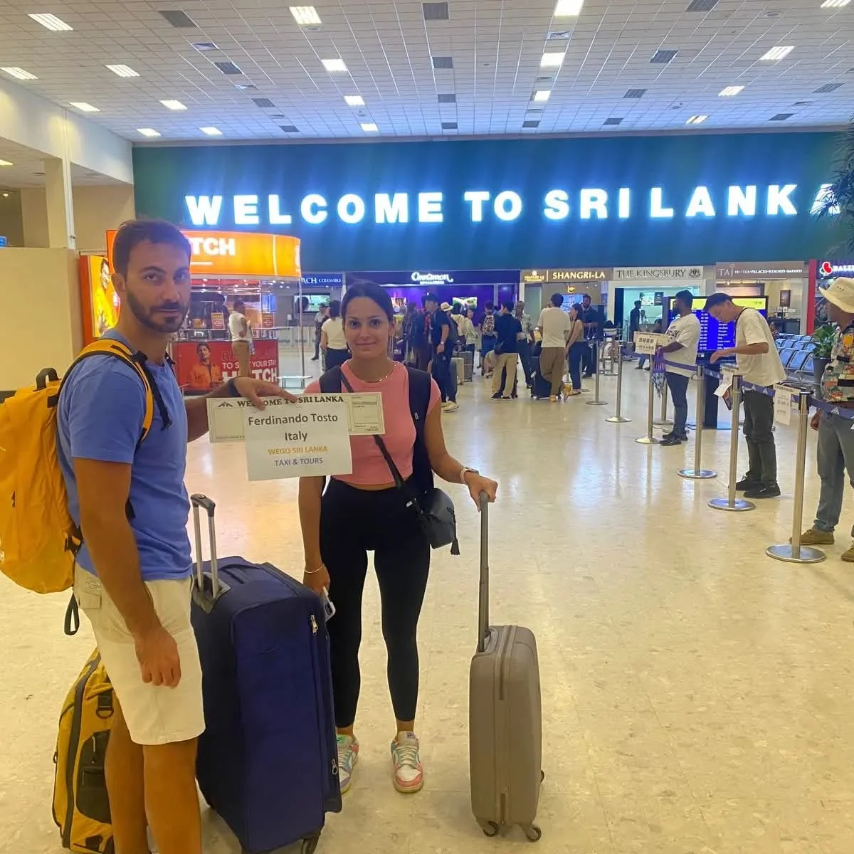 Tourists arrival at Colombo Airport Sri Lanka - International travelers being greeted with Welcome to Sri Lanka sign at Bandaranaike International Airport